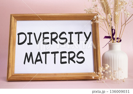 Diversity matters symbol. Concept words Diversity matters on beautiful wooden picture frame. Beautiful pink background with flower vase. Business and Diversity matters concept. Copy space. Diversity matters symbol. Concept words Diversity matters on beautiful wooden picture frame. Beautiful pink background with flower vase. Business and Diversity matters concept. Copy space. 136009031