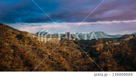 Mutianyu Great Wall section with watchtower, winding stone path, autumn vegetation landscape 136009089