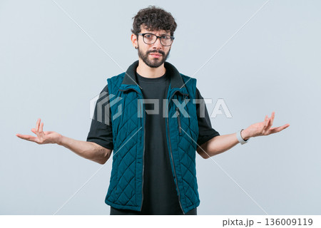 Confused man spreading hands bewildered isolated. Unsure person with face worried Confused man spreading hands bewildered isolated. Unsure person with face worried 136009119