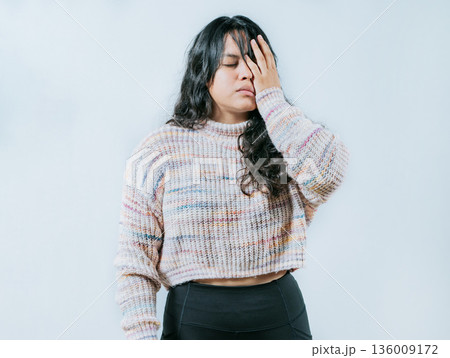 Exhausted young woman putting the palm on his face isolated. Tired and exhausted person covering his face with the palm of hand Exhausted young woman putting the palm on his face isolated. Tired and exhausted person covering his face with the palm of hand 136009172
