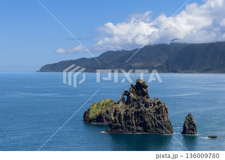 Rocky sea stacks Ilheus da Ribeira da Janela rise from calm Atlantic waters Madeira coast lookout 136009780