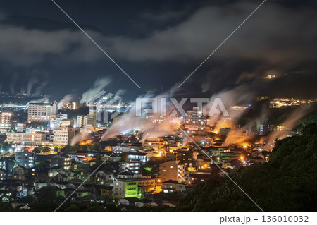 Aerial view of Beppu town with motion steam hot spring at night 136010032