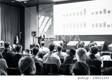 Speaker giving a talk in conference hall at business event. Black and white image 136011243
