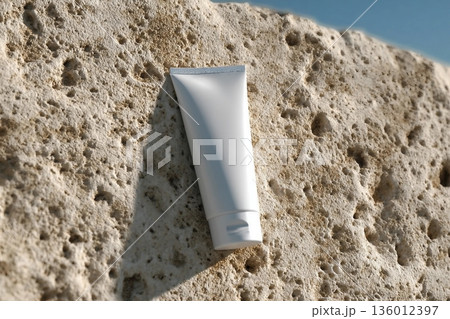 Mockup of a clean white tube on rocky seashore. Ideal presentation for sunblock, soothing face cream, skin care or beauty product packaging design. Mockup of a clean white tube on rocky seashore. Ideal presentation for sunblock, soothing face cream, skin care or beauty product packaging design. 136012397