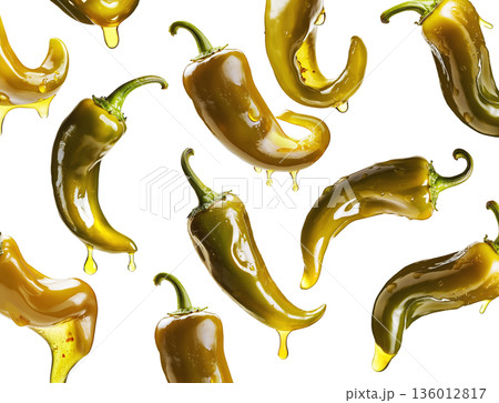 Shiny green chili peppers covered in oil, isolated on white background, emphasizing food freshness and culinary splash concept 136012817