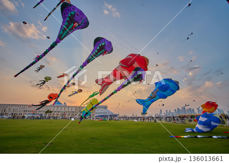 Doha, Qatar - January 20 2026: Qatar Kite Festival 2026 in Old Doha port (Mina District) sunset shot showing spectacular showcase of colorful kites soaring across the picturesque Doha skyline. Doha, Qatar - January 20 2026: Qatar Kite Festival 2026 in Old Doha port (Mina District) sunset shot showing spectacular showcase of colorful kites soaring across the picturesque Doha skyline. 136013661