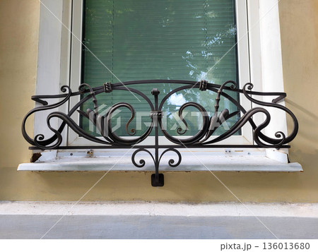 A white window with a black wrought-iron lattice for placing flower pots A white window with a black wrought-iron lattice for placing flower pots 136013680