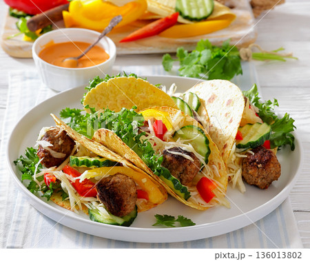 lamb meatball tacos with fresh veggies on a plate lamb meatball tacos with fresh veggies on a plate 136013802