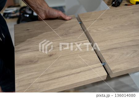 Shop scene involving walnut panel cutting process. Detailed workshop scene showing manual walnut cut with measuring and guiding tools 136014080