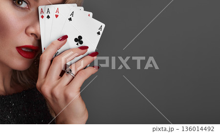 Four Aces Held By Woman Glamorous Closeup Red Lips Red Nails Diamond Ring Sequined Dress Confident Gaze Professional Poker Player Pose High Stakes Poker Vibe Studio Gray Background 136014492