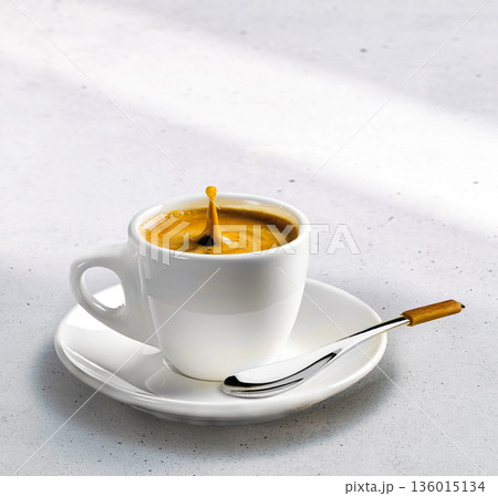 A serene coffee set with one cup on a saucer on a stone under the gentle sunlight A serene coffee set with one cup on a saucer on a stone under the gentle sunlight 136015134