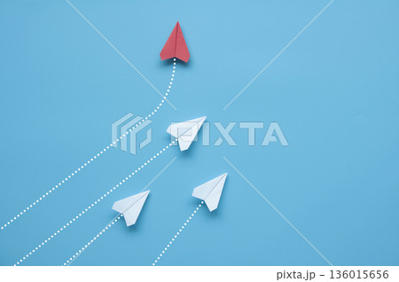 Paper airplane leaving motion trail on blue background symbolizing speed progress and decisive action. Paper airplane leaving motion trail on blue background symbolizing speed progress and decisive action. 136015656