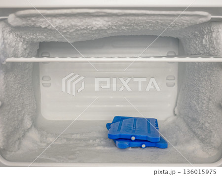Frosted Freezer Interior with Ice Packs and Heavy Ice Buildup 136015975