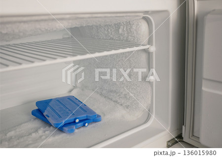 Icy Freezer Shelf with Ice Packs and Frost Buildup Icy Freezer Shelf with Ice Packs and Frost Buildup 136015980