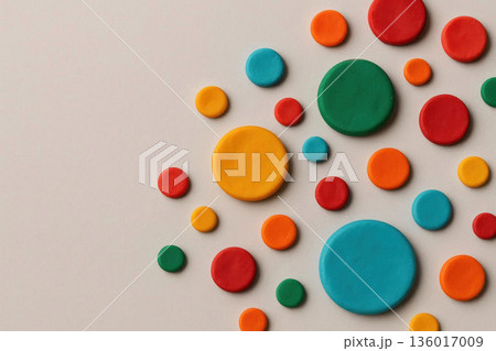 Multi-colored round figures made of plasticine on a light background. Space for text. Multi-colored round figures made of plasticine on a light background. Space for text. 136017009