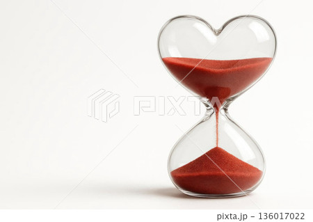 Heart-shaped hourglass with red sand. Space for text. Heart-shaped hourglass with red sand. Space for text. 136017022