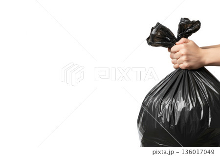 Holding a tied garbage bag with your hand. Space for text. Holding a tied garbage bag with your hand. Space for text. 136017049