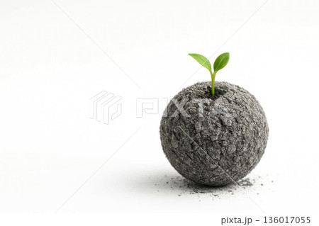 An earthen ball with a sprout on a white background. Space for text. 136017055