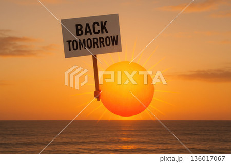 Sun with a sign Back Tomorrow against the background of the sunset. 136017067