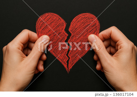 Hands tearing a red paper heart. 136017104