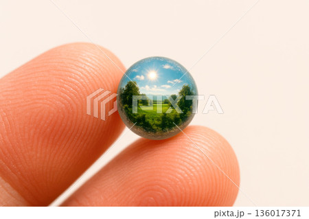 Landscape in a glass spherical capsule at the tip of your fingers. Space for text. 136017371