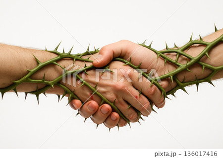 A handshake entangled in thorny vines on a light background. Space for text. A handshake entangled in thorny vines on a light background. Space for text. 136017416