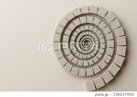 Spiral of stone squares on a light background. Space for text. 136017450