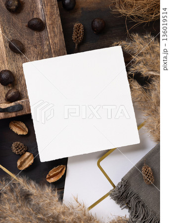 Square card on wooden tray near brown decor and pampas grass top view, boho mockup Square card on wooden tray near brown decor and pampas grass top view, boho mockup 136019514