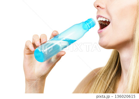 woman holding bottle of liquid cosmetic, having fun, enjoying morning routine procedure for skincare. woman holding bottle of liquid cosmetic, having fun, enjoying morning routine procedure for skincare. 136020615