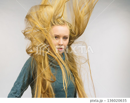 Girl with hair flying around her face Girl with hair flying around her face 136020635