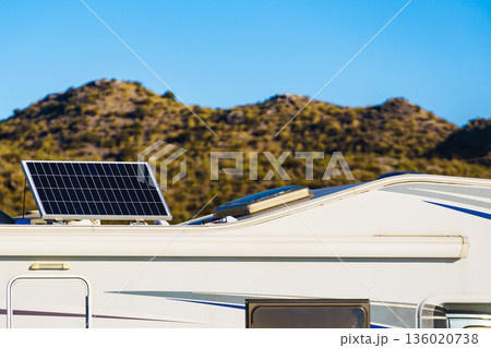 Caravan with tilt solar panels on roof. 136020738