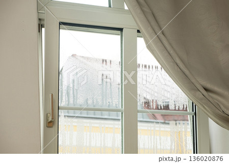 Plastic window with heavy condensation and water droplets. Indoor humidity problem Plastic window with heavy condensation and water droplets. Indoor humidity problem 136020876