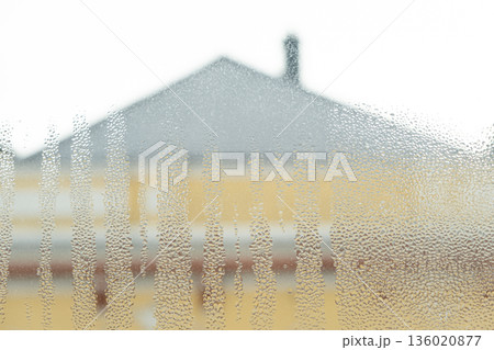 Wet window glass surface with heavy moisture and misted texture. Wet window glass surface with heavy moisture and misted texture. 136020877