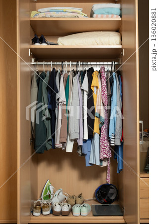 Realistic messy wardrobe interior with different garments and sneakers Realistic messy wardrobe interior with different garments and sneakers 136020881