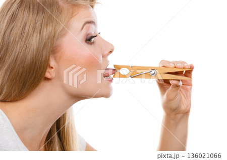 Blonde woman having tongue in clothespin 136021066