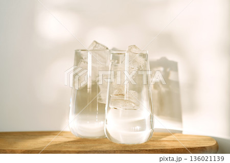 Two glasses of refreshing water with ice cubes Two glasses of refreshing water with ice cubes 136021139