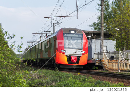 A bright red orange modern passenger train 136021856