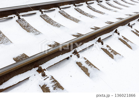 Perspective view of a snow covered railroad tracks 136021866