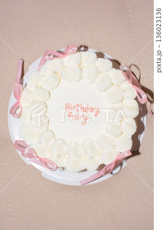 vintage cake with pink bows of delicate cream color, top view vintage cake with pink bows of delicate cream color, top view 136023136