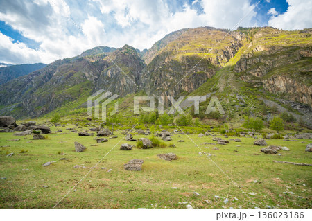 Chulyshman valley in Altai Russia with mountains and massive boulders scattered after earthquake Dramatic natural landscape shaped by seismic activity 136023186