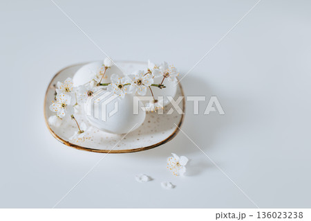 Beautiful branch with white blossom and eggs on a white background. Minimal concept. Beautiful branch with white blossom and eggs on a white background. Minimal concept. 136023238