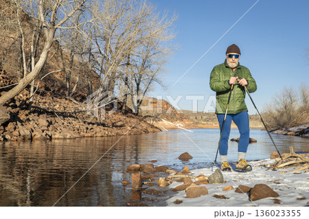 senior male hiker with trekking poles on a trail in Lory State Park in Colorado foothills 136023355