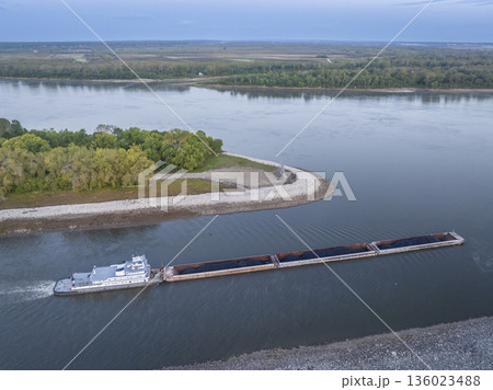 towboat with barges loaded with coal is entering the Mississippi River from the Chain of Rock Canal of above St Louis, aerial view in October dawn scenery towboat with barges loaded with coal is entering the Mississippi River from the Chain of Rock Canal of above St Louis, aerial view in October dawn scenery 136023488
