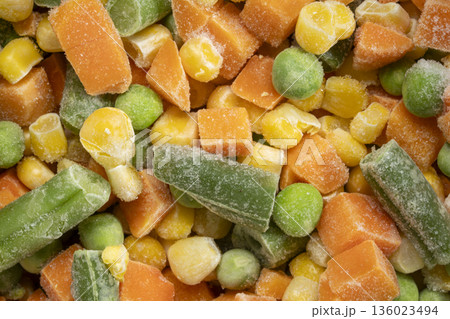 closeup background and texture of frozen vegetable medley - carrots, peas, green beans and corn closeup background and texture of frozen vegetable medley - carrots, peas, green beans and corn 136023494