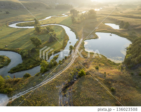 sunrise over a river meandering through Nebraska Sandhills - aerial view of Middle Loup River near Mullen sunrise over a river meandering through Nebraska Sandhills - aerial view of Middle Loup River near Mullen 136023508