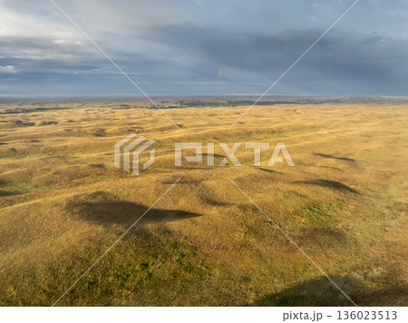 storm clouds with a rainbow over Nebraska Sandhills and Dismal River, late summer aerial view 136023513