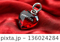 Sparkling Red Heart Pendant with "Forever" Engraved, Symbolizing Enduring Love and Romance on a Silk Background 136024284