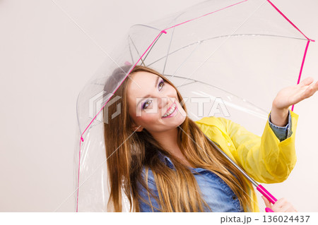 Woman in rainproof coat with umbrella. Forecasting 136024437