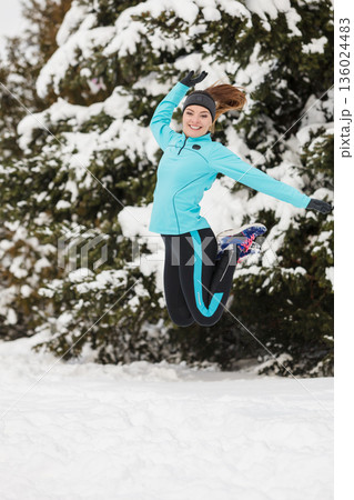 Winter sport, girl jumping in snow Winter sport, girl jumping in snow 136024483