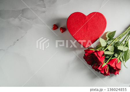Valentine's Day background. Red roses flowers and heart gift box on bright background. Festive greeting card, flat lay Valentine's Day background. Red roses flowers and heart gift box on bright background. Festive greeting card, flat lay 136024855